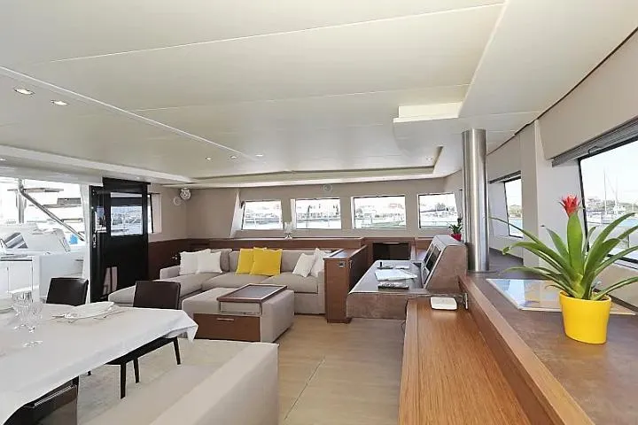 Masterdream Yacht Photos Pics Luxurious interior of 2018 Lagoon 620 Esense yacht with modern furnishings and large windows.