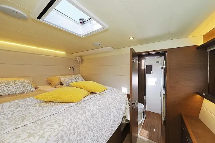 Masterdream Yacht Photos Pics Luxurious cabin interior of 2018 Lagoon 620 Esense yacht with elegant bedding and ensuite bathroom.