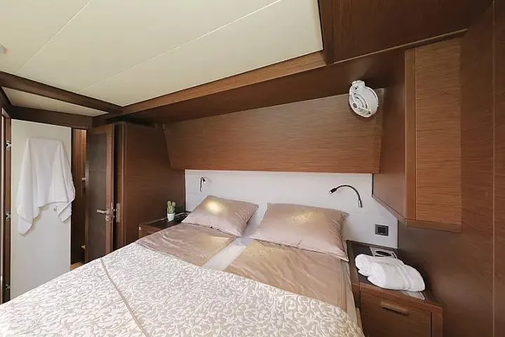 Masterdream Yacht Photos Pics Luxurious cabin interior of 2018 Lagoon 620 Esense yacht with elegant bedding and wood finish.