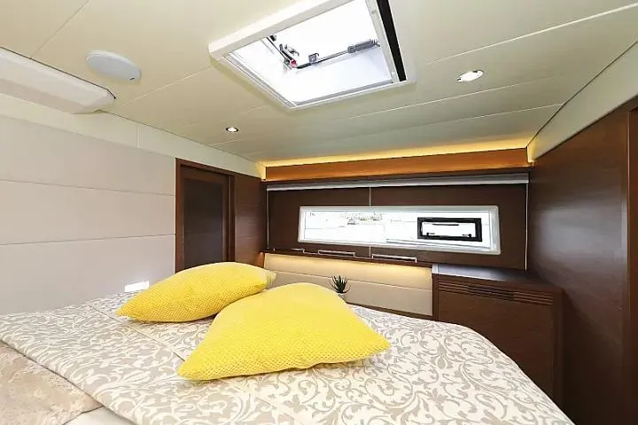 Masterdream Yacht Photos Pics Luxurious cabin interior of 2018 Lagoon 620 Esense yacht with elegant bedding and yellow pillows.