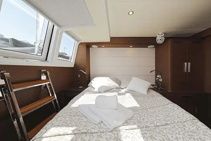 Masterdream Yacht Photos Pics Luxurious cabin interior of 2018 Lagoon 620 Esense yacht with elegant bedding and natural light.
