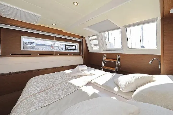 Masterdream Yacht Photos Pics Luxurious interior of 2018 Lagoon 620 Esense yacht with elegant bedding and natural light.