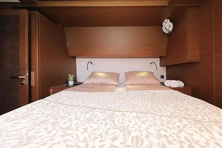 Masterdream Yacht Photos Pics Luxurious bedroom interior of 2018 Lagoon 620 Esense yacht with elegant bedding and wood finish.