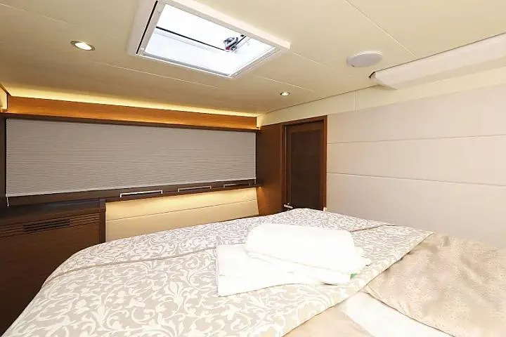 Masterdream Yacht Photos Pics Luxurious cabin interior of 2018 Lagoon 620 Esense yacht with elegant bedding and skylight.