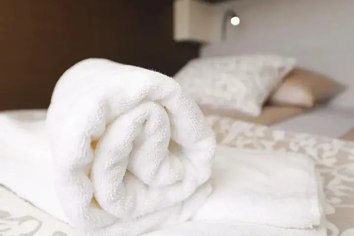 Masterdream Yacht Photos Pics Rolled white towel on bed in Lagoon 620 Esense, 2018 model yacht interior.