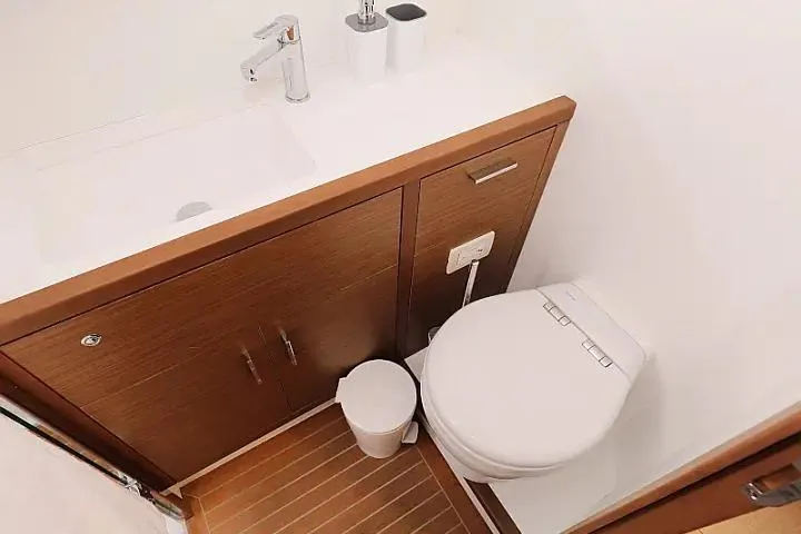 Masterdream Yacht Photos Pics Modern bathroom in 2018 Lagoon 620 Esense yacht with sleek fixtures and wooden cabinetry.