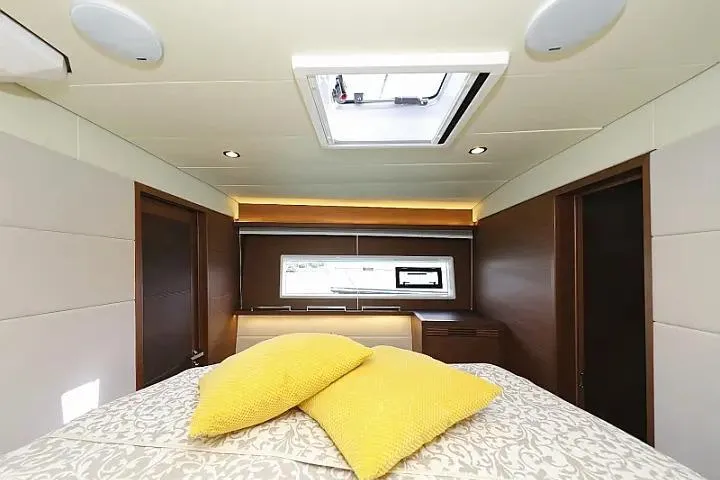 Masterdream Yacht Photos Pics Luxurious bedroom interior of 2018 Lagoon 620 Esense yacht with skylight and yellow pillows.