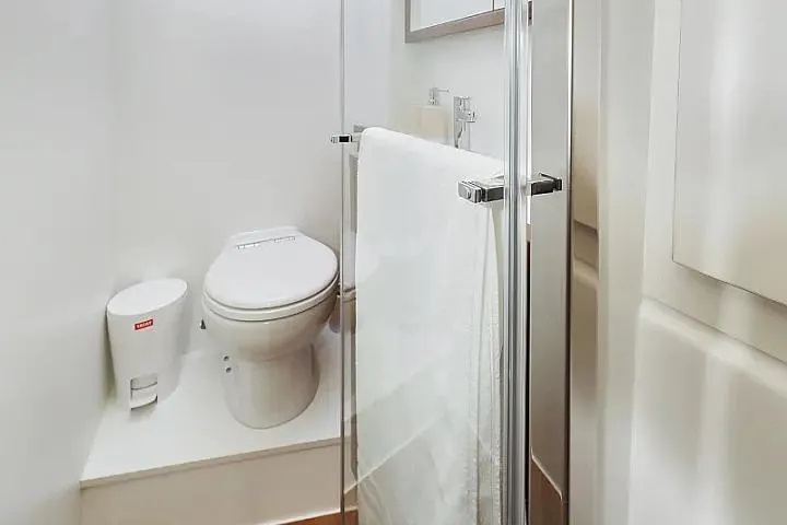 Masterdream Yacht Photos Pics Bathroom interior of 2018 Lagoon 620 Esense yacht, featuring toilet and glass shower.