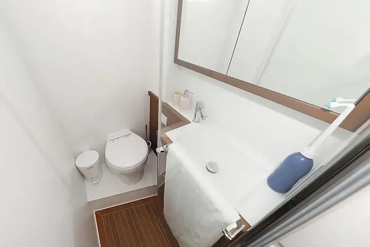 Masterdream Yacht Photos Pics Compact bathroom in 2018 Lagoon 620 Esense yacht with modern fixtures and wooden flooring.
