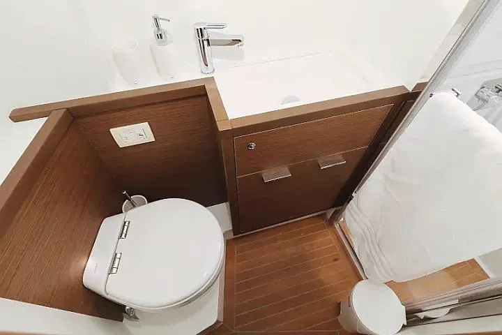 Masterdream Yacht Photos Pics Luxurious bathroom in 2018 Lagoon 620 Esense yacht with modern fixtures and wood accents.