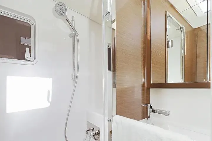 Masterdream Yacht Photos Pics Luxurious bathroom in 2018 Lagoon 620 Esense yacht with modern fixtures and wooden accents.