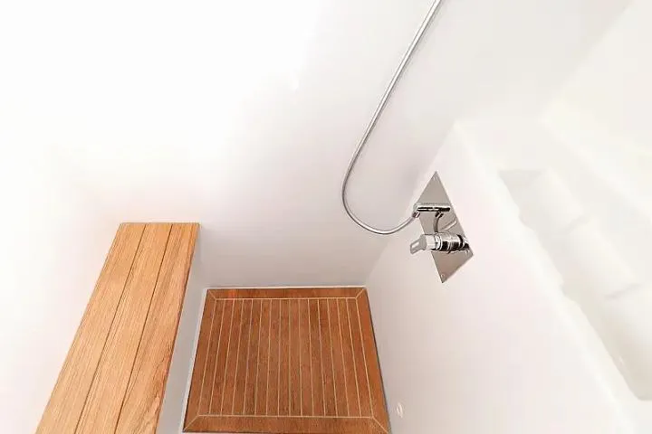 Masterdream Yacht Photos Pics Modern shower area with wooden bench and floor in Lagoon 620 Esense yacht.