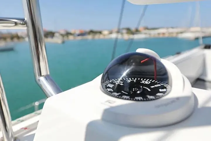 Masterdream Yacht Photos Pics Compass on Lagoon 620 Esense yacht, 2018, with blurred marina background.