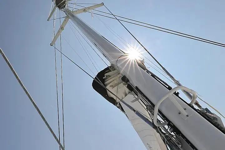 Masterdream Yacht Photos Pics Mast of 2018 Lagoon 620 Esense sailboat with sun shining through rigging.