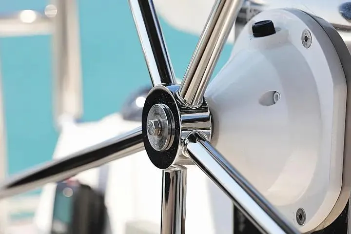 Masterdream Yacht Photos Pics Close-up of a 2018 Lagoon 620 Esense yacht steering wheel, showcasing sleek chrome details.
