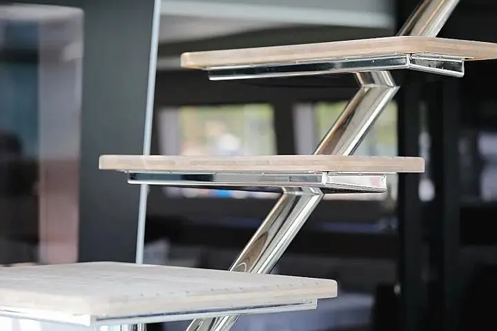 Masterdream Yacht Photos Pics Modern staircase design on 2018 Lagoon 620 Esense yacht, featuring sleek metal and wood elements.