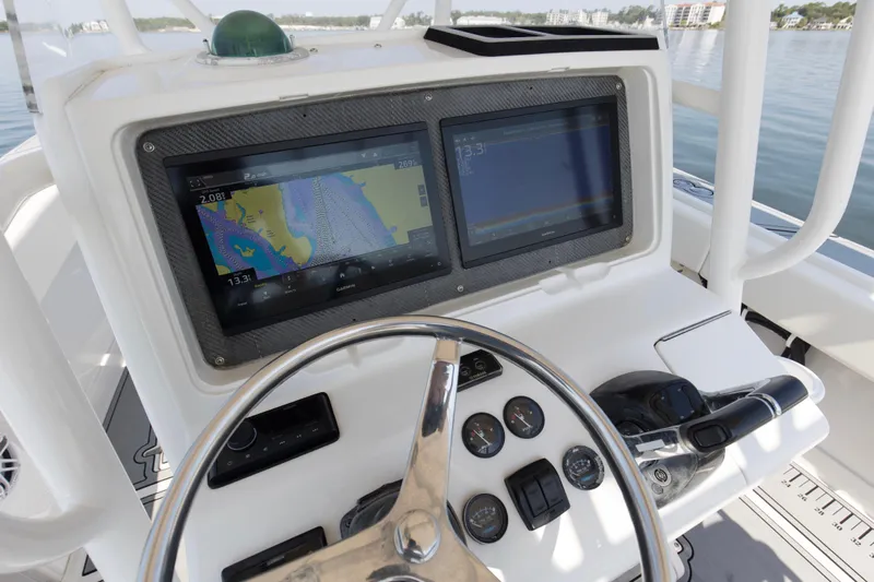 Smoke Show Yacht Photos Pics 2004 Jupiter 31 FS boat dashboard with navigation screens and steering wheel.