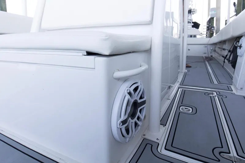 Smoke Show Yacht Photos Pics 2004 Jupiter 31 FS boat interior with speaker and cushioned seating.