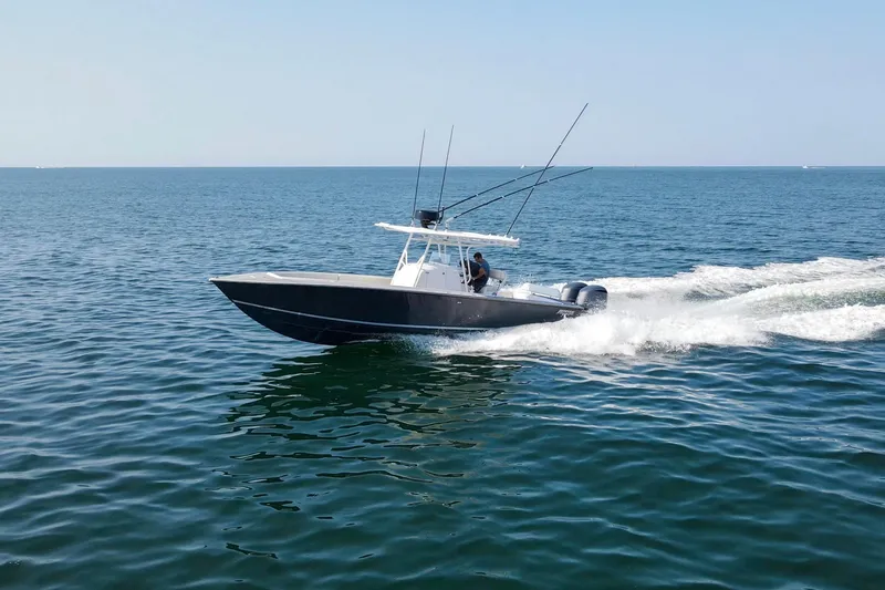 Smoke Show Yacht Photos Pics 2004 Jupiter 31 FS boat cruising on open water, clear sky background.
