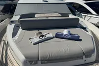 2023 Absolute 60 Fly yacht with sunbathing area and branded towels on deck.