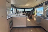 Luxurious interior of 2023 Absolute 60 Fly yacht with modern kitchen and panoramic windows.