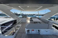Luxurious 2023 Absolute 60 Fly yacht deck with seating, overlooking marina.