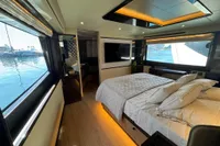 Luxurious interior of 2023 Absolute 60 Fly yacht with elegant bedroom and scenic ocean views.
