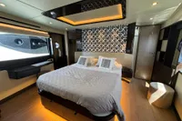 Luxurious bedroom interior of 2023 Absolute 60 Fly yacht with modern design and ambient lighting.