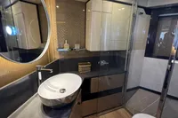 Luxurious bathroom in 2023 Absolute 60 Fly yacht with modern fixtures and elegant design.