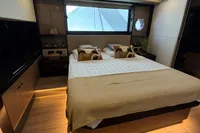 Luxurious bedroom interior of 2023 Absolute 60 Fly yacht with modern design and ambient lighting.
