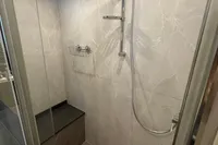Modern shower in 2023 Absolute 60 Fly yacht with sleek design and marble walls.