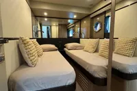Luxurious interior of 2023 Absolute 60 Fly yacht with twin beds and modern decor.