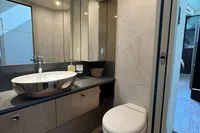 Luxurious bathroom in 2023 Absolute 60 Fly yacht with modern fixtures and elegant design.