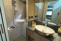 Luxurious bathroom in 2023 Absolute 60 Fly yacht with modern fixtures and elegant design.