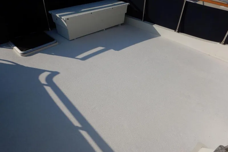  Yacht Photos Pics 1980 Tollycraft 48 Cockpit Motor Yacht deck with storage box and railing shadows.