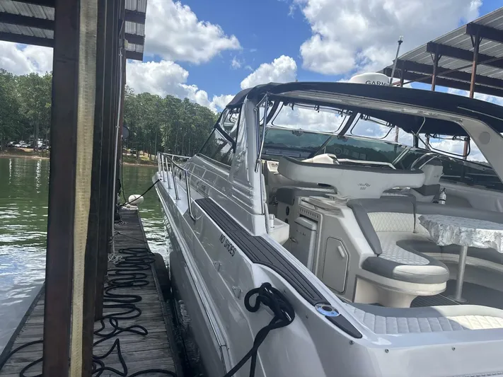 Forget About It Yacht Photos Pics 1996 Sea Ray 500 Sundancer yacht docked, featuring spacious seating and sleek design.