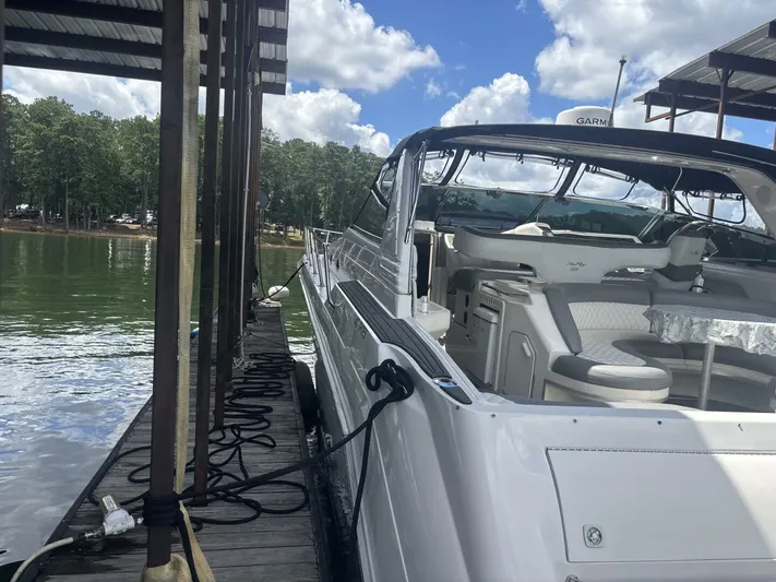 Forget About It Yacht Photos Pics Sea Ray 500 Sundancer 1996 docked, featuring spacious seating and clear skies.