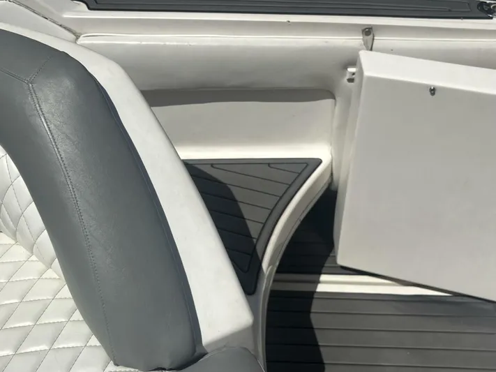 Forget About It Yacht Photos Pics 1996 Sea Ray 500 Sundancer interior with gray and white seating and open storage compartment.