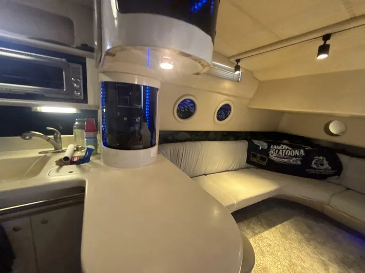 Forget About It Yacht Photos Pics Interior of 1996 Sea Ray 500 Sundancer yacht with kitchenette and seating area.