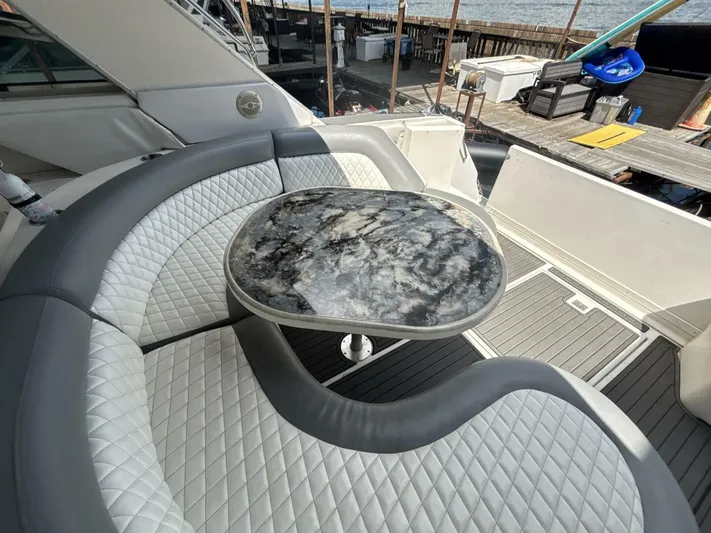 Forget About It Yacht Photos Pics Luxurious seating area on a 1996 Sea Ray 500 Sundancer yacht with a marble table.