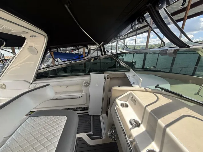 Forget About It Yacht Photos Pics 1996 Sea Ray 500 Sundancer interior with seating and helm, docked by the water.