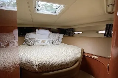  Yacht Photos Pics Luxurious cabin interior of 1998 Sea Ray 540 Sundancer yacht with cozy bedding.