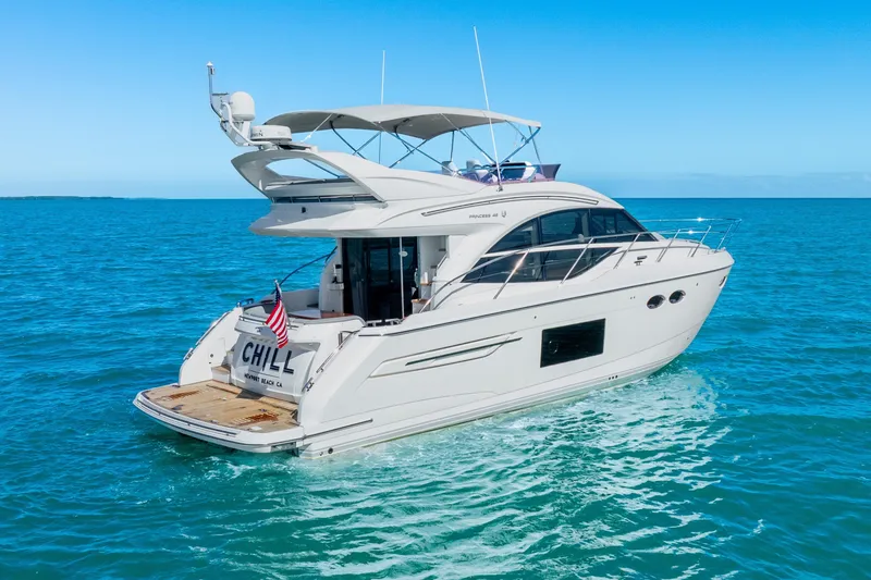 Chill Yacht Photos Pics Luxurious 2018 Princess F49 yacht cruising on clear blue ocean waters.