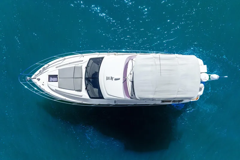 Chill Yacht Photos Pics Aerial view of 2018 Princess F49 yacht cruising in clear blue waters.