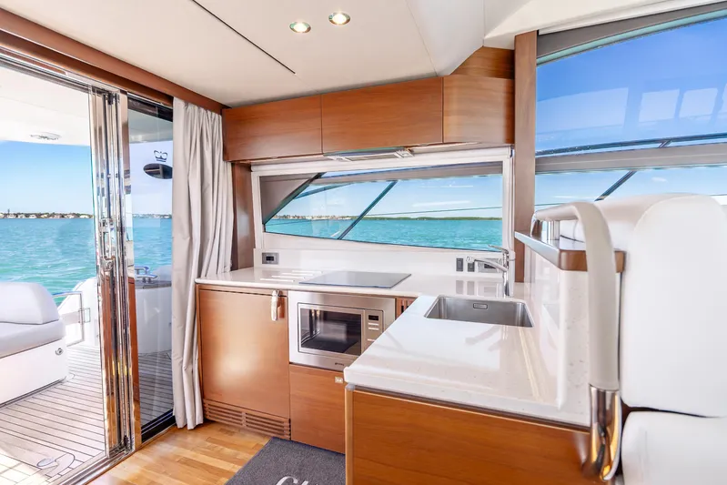 Chill Yacht Photos Pics Luxurious interior of 2018 Princess F49 yacht with modern kitchen and ocean view.