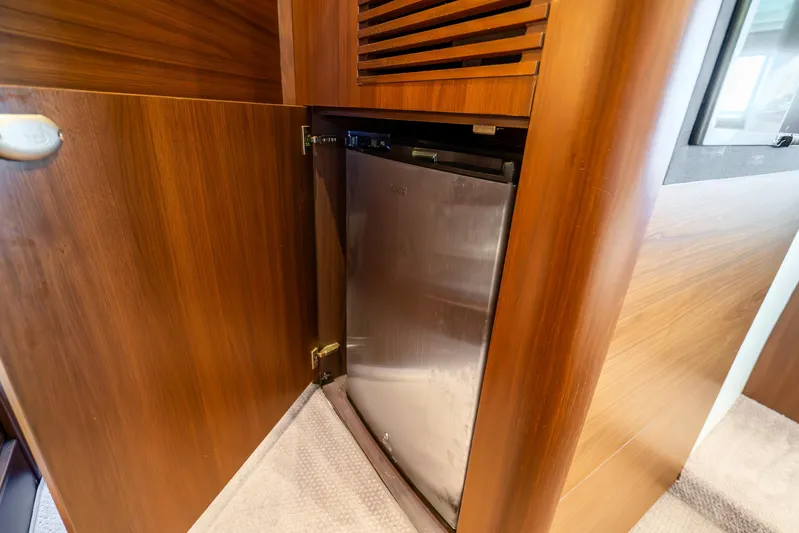 Chill Yacht Photos Pics Wooden cabinet with built-in fridge on 2018 Princess F49 yacht.