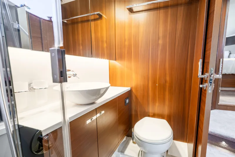 Chill Yacht Photos Pics Luxurious bathroom in 2018 Princess F49 yacht with wooden cabinetry and modern fixtures.