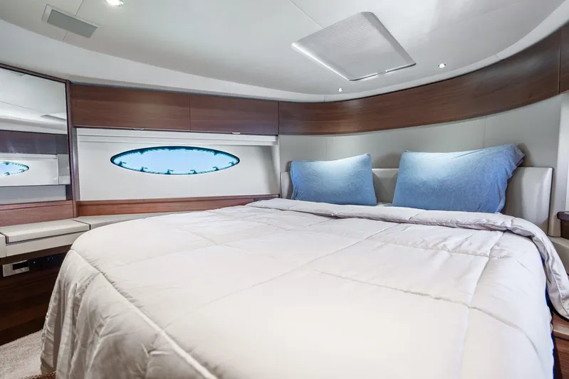 Chill Yacht Photos Pics Luxurious bedroom interior of 2018 Princess F49 yacht with modern design and cozy bedding.