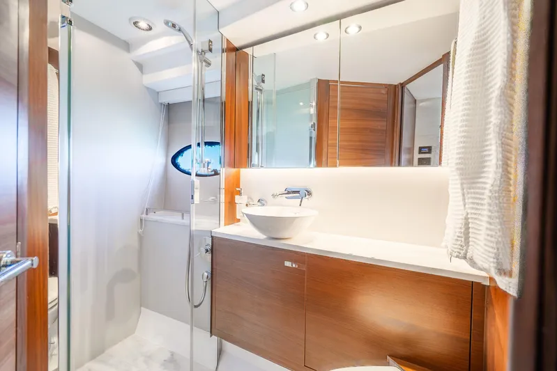 Chill Yacht Photos Pics Luxurious bathroom in 2018 Princess F49 yacht with modern fixtures and elegant wood accents.