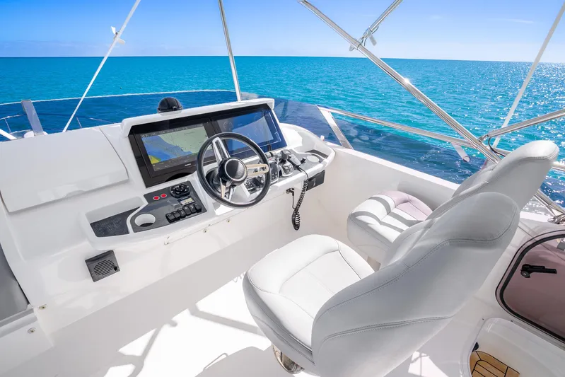 Chill Yacht Photos Pics Helm of 2018 Princess F49 yacht with ocean view, featuring modern navigation equipment.
